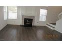 Bright living room featuring modern fireplace, wood floors, and ample natural light at 8416 Shore Breeze Dr, Las Vegas, NV 89128