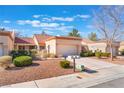 Inviting single-story home with desert landscaping, tile roof, and attached two-car garage at 8617 Prairie Hill Dr, Las Vegas, NV 89134