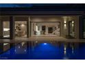 Stunning pool at night with interior view of the home at 8913 Canyon Springs Dr, Las Vegas, NV 89117