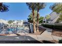 Community pool area with surrounding trees and walkway at 8945 Clairton Ct, Las Vegas, NV 89117