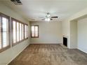 Spacious living room with a fireplace and large windows at 1175 Lake Berryessa St, Henderson, NV 89002