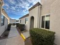 Front entrance with walkway, landscaping, and stucco exterior at 2148 Pebble Creek Ln, Laughlin, NV 89029