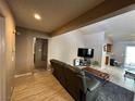 Living room with leather couches, coffee table, and wood-look flooring at 2148 Pebble Creek Ln, Laughlin, NV 89029