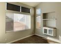 Bright living room with hardwood floors, built-in shelving, and large windows at 2503 Lady Elizabeth Ct, North Las Vegas, NV 89031