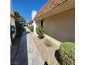Side view of the house with walkway and landscaping at 2732 Heritage Ct # 0, Las Vegas, NV 89121