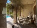 Covered patio with stylish outdoor furniture, perfect for relaxing by the poolside at 312 N Royal Ascot Dr, Las Vegas, NV 89144