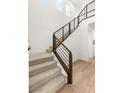 Modern staircase with wood and metal railings, leading to the second floor at 3243 Fountaintree Ave, Henderson, NV 89044