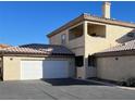 Two-story house with attached garage, balcony, and Spanish-style roof at 3604 Monarcas St # 101, Las Vegas, NV 89108