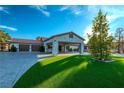 Striking house with a red tile roof, paved driveway, and lush green lawn creating great curb appeal at 5353 Dorrell Ln, Las Vegas, NV 89131