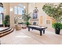 Spacious living room with high ceilings, large windows, fireplace, and comfortable seating at 5455 San Florentine Ave, Las Vegas, NV 89141
