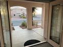 Inviting front entryway with decorative glass door and view of the home's exterior and well-maintained front yard at 5836 Aimless St, Henderson, NV 89011