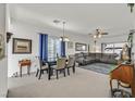 Open dining area with table, chairs, and view into living room at 6072 Isola Peak Ave, Las Vegas, NV 89122