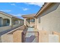 Front entry with walkway, gate, and seating area at 6072 Isola Peak Ave, Las Vegas, NV 89122