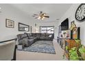Spacious living room with sectional sofa, large TV, and area rug at 6072 Isola Peak Ave, Las Vegas, NV 89122