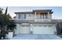 Two-story home with a large driveway and attached two-car garage at 7501 Midnight Rambler St, Las Vegas, NV 89149