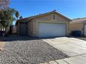 Tan house with a white garage door and desert landscaping at 1420 Arlington Heights St, Las Vegas, NV 89110