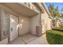 Front door with a white metal security door and small porch at 1473 Teddington Ct # 101, Las Vegas, NV 89102