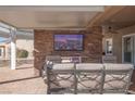 Outdoor patio with seating and fireplace at 1645 Warrington Dr, Henderson, NV 89052