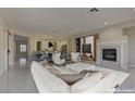 Virtually staged living room features modern furniture and fireplace at 1656 Black Fox Canyon Rd, Henderson, NV 89052