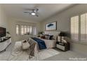 Virtually staged main bedroom with large window and neutral tones at 1656 Black Fox Canyon Rd, Henderson, NV 89052