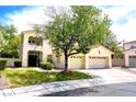 Two-story house with a large front yard, two-car garage, and mature trees at 1813 Francisco Peak Pl, Las Vegas, NV 89128