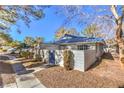 Side view of a house with blue roof tiles and a walkway at 2132 Petersham Ct # D, Las Vegas, NV 89108