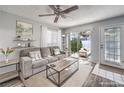 Living room with gray couch, wood floors, and access to a patio at 2132 Petersham Ct # D, Las Vegas, NV 89108