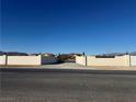 Property entrance with a long driveway and walls on either side at 3720 W Charleston Park Ave, Pahrump, NV 89048