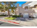 Townhome exterior with a driveway and landscaping at 503 Fragrant Orchard St, Henderson, NV 89015