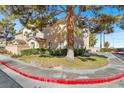 Townhome side view, showcasing landscaping and a large tree at 503 Fragrant Orchard St, Henderson, NV 89015