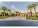 Grand estate with a yellow facade and manicured landscaping at 52 Innisbrook Ave, Las Vegas, NV 89113