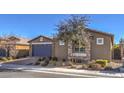 House exterior with gray garage door and stone accents at 6288 Starflare St, Las Vegas, NV 89148