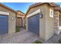 Gray two-car garage with walkway to front door at 6288 Starflare St, Las Vegas, NV 89148