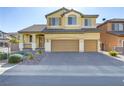 Two-story house with a landscaped yard and two-car garage at 633 Finch Island Ave, Henderson, NV 89015