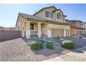 Two-story house with a landscaped yard and two-car garage at 633 Finch Island Ave, Henderson, NV 89015