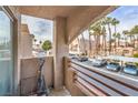 Apartment balcony overlooking parking lot and pool area with palm trees at 6861 Tamarus St # 203, Las Vegas, NV 89119