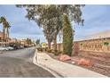 Sunset Bay community entrance with landscaping and signage at 6861 Tamarus St # 203, Las Vegas, NV 89119