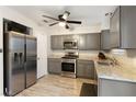 Modern kitchen with gray cabinets, granite countertops, and stainless steel appliances at 7336 Young Doe Ave, Las Vegas, NV 89130