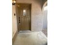 Brown front door with glass accents and keypad entry at 7509 W Gilmore Ave, Las Vegas, NV 89129