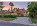 Stunning Spanish style home with lush landscaping and palm trees at 8199 Pinnacle Peak Ave, Las Vegas, NV 89113