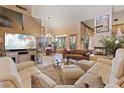 Spacious living room with unique fireplace and neutral tones, perfect for relaxation and entertaining guests at 8199 Pinnacle Peak Ave, Las Vegas, NV 89113