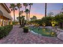 Resort style pool with lush tropical plants and landscape for backyard privacy at 8199 Pinnacle Peak Ave, Las Vegas, NV 89113