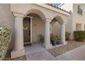 Inviting front entry with arched entryway and covered porch at 1036 Campo Seco Ct, Las Vegas, NV 89138