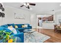Open living area with hardwood floors and a blue sectional sofa at 1036 Campo Seco Ct, Las Vegas, NV 89138