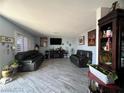 Spacious living room with gray tile floors and two black reclining sofas at 1152 Miller Ave, Las Vegas, NV 89106