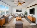 Virtually staged living room featuring a comfortable sofa and mid-century modern decor at 12124 Mojave Gold Rd # 2, Las Vegas, NV 89183