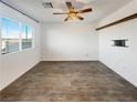 Bright and airy spare bedroom with wood-look flooring and large window at 12124 Mojave Gold Rd # 2, Las Vegas, NV 89183