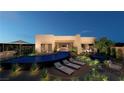 Modern home with a sleek, infinity-edge pool and relaxing lounge area at 129 Still Shores St, Henderson, NV 89011
