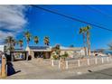 Cozy home featuring a covered parking area and a well-maintained front yard with palm trees at 132 Continental Ave, Henderson, NV 89015