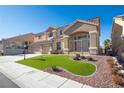 Two-story house with a three-car garage and landscaped lawn at 1559 Via Della Scala, Henderson, NV 89052